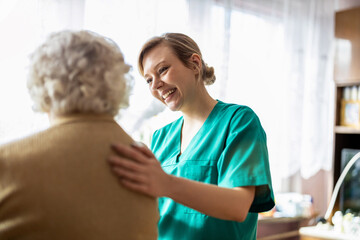 Friendly nurse supporting an elderly lady
 - Powered by Adobe