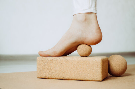 Close up of foot, heel on cork massage ball for plantar fascia MFR