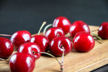 Fresh cherries on a wooden cutting board