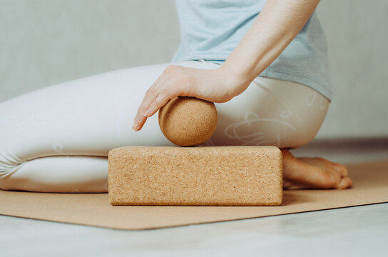 Side view of person doing palmar fascia release with a large cork ball on a cork block 