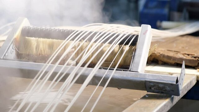 Plastic strands go to strand cutter to recycle plastic and create pellets from pellet mill after hydrocooling with water, industrial concept, recyclable, and pellets for recycling plastic