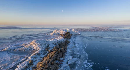 Fototapeten Pier Beautiful shot of a frozen lake at sunset  © Mati Kose/Wirestock