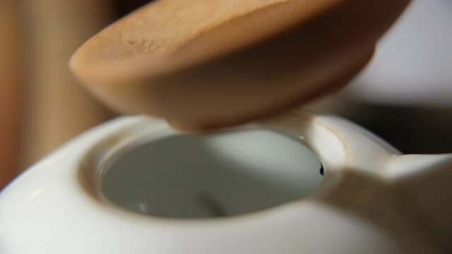 The tea master pours tea from the chahe into the teapot. Slow motion close-up, macro shot. Traditional Chinese tea drinking ceremony. Chinese Japanese tea, Puer Shu Gong Ting Xiao Tocha Oolong Zhang