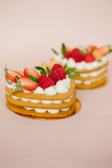 Cake with cream and strawberries in the shape of a heart on the background. Cooking.