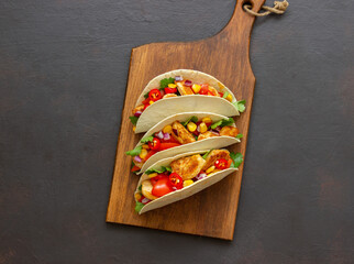 Tacos with chicken, tomatoes, corn and onions. Mexican food. Fast food.