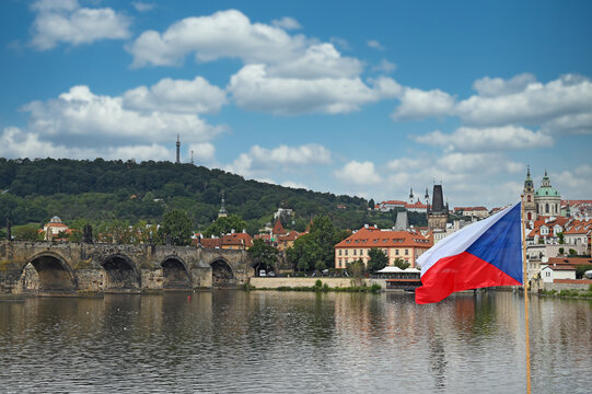 Charles bridge and Czech flag Prague cityscape