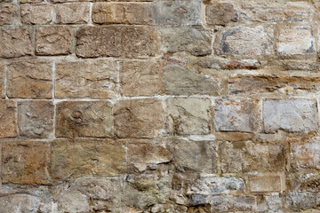 Old brick wall with hewn stone for texture and background in design. Texture and background of old stone wall memo architecture as background and texture.