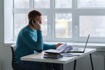 guy works from home. man using laptop, typing on keyboard, writing email or message, chatting, shopping, successful freelancer working online on computer.