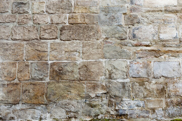 Old brick wall with hewn stone for texture and background in design. Texture and background of old stone wall memo architecture as background and texture.