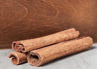 Cinnamon sticks on a wooden background.