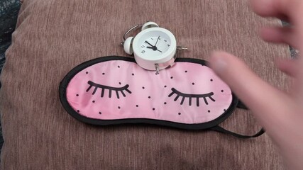 Sleeping eye mask, alarm clock black background. Rest, good night, insomnia, relaxation concept - Powered by Adobe