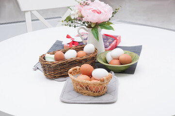 Easter eggs in the wickers baskets at home interior