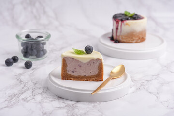 Modern cheesecake with blueberry jam and panna cotta