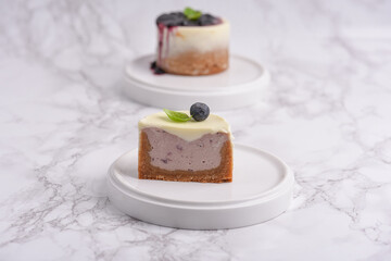 Modern cheesecake with blueberry jam and panna cotta