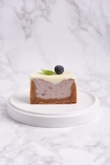 Modern cheesecake with blueberry jam and panna cotta