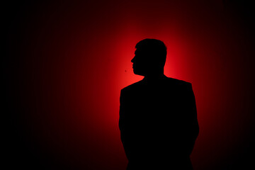 Silhouette of a man on a red background.