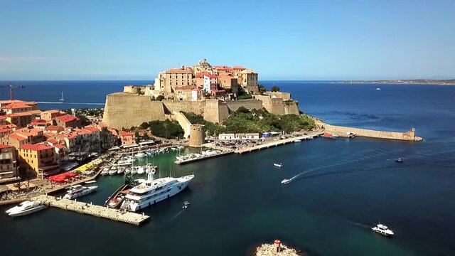 Citadel of Calvi with the port and the Mediterranean Sea, Corsica France. Drone takes off in front of the Citalle