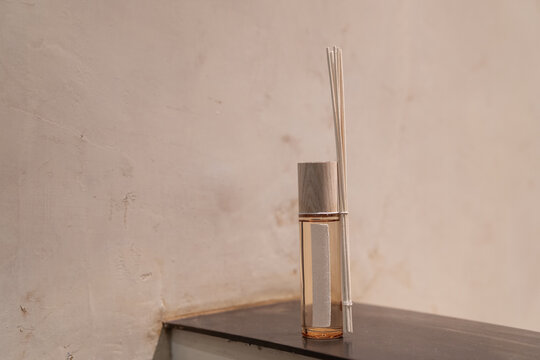 Reed Diffuser, Home Perfume Decor, Clear Glass Bottle On Warm Neutral Colors Cement Wall. Brand Packaging Mockup. Minimalist Product Photography Still Life