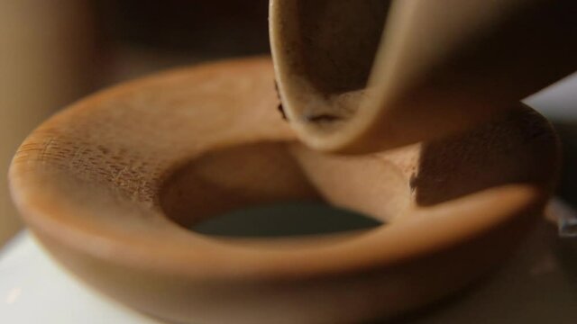 The tea master pours tea from the chahe into the teapot. Slow motion close-up, macro shot. Traditional Chinese tea drinking ceremony. Chinese Japanese tea, Puer Shu Gong Ting Xiao Tocha Oolong Zhang