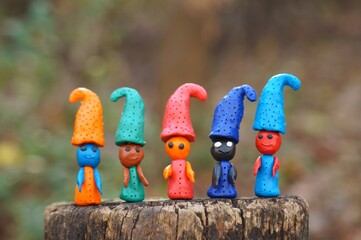 Figures of multi-colored gnomes on a colored background.