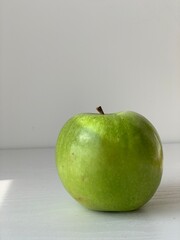 green apple on a golden background as an example of healthy food