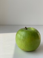 green apple on a golden background as an example of healthy food