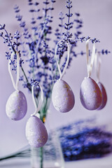 Purple Easter eggs hanging on lavender branches