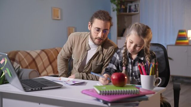 home education, father helps his pupil daughter do homework while sitting at table with a laptop, family is upset because of an impossible task