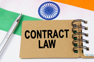 Against the background of the flag of India lies a notebook with the inscription - CONTRACT LAW