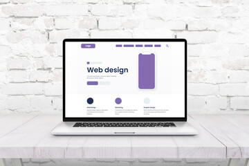 Laptop computer with web page layout. Concept of web and graphic design studio