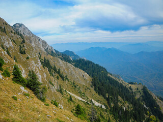 Fototapeta premium Photo taken from the abrupt crests of Buila Mountains. Calcareous cliffs populate the abrupt mountain sides of the Massif. Carpathia, Romania.