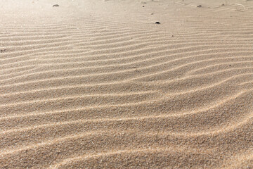 Fototapeta na wymiar Sand background.Sand ripple.Sand texture.Beautiful nature background.Summer landscape. Golden sands.