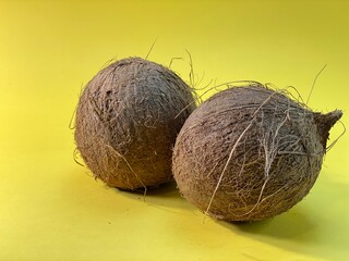 on a yellow background lies a coconut © Józef