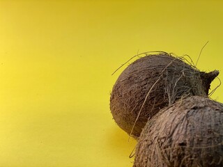 on a yellow background lies a coconut © Józef
