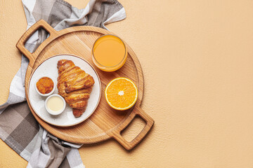 Wooden tray with tasty breakfast on color background