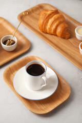 Wooden trays with tasty breakfast on light background