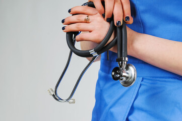 Close-up of unknown female doctor with stethoscope isolated