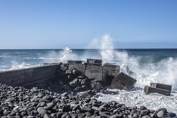 Beautiful big Ocean waves coming to the Atlantic shore Tenerife. Puerto de la Cruz town, Tenerife, Canary Islands, Spain.