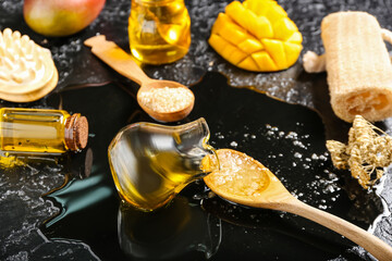 Composition with mango essential oil on dark background