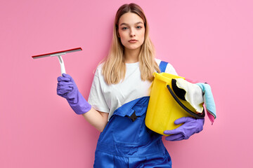 young caucasian female is exhausted of cleaning, holding cleanser things