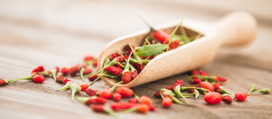 Ripe goji berries on wooden background