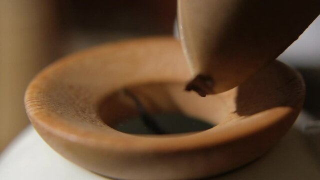 The tea master pours tea from the chahe into the teapot. Slow motion close-up, macro shot. Traditional Chinese tea drinking ceremony. Chinese Japanese tea, Puer Shu Gong Ting Xiao Tocha Oolong Zhang