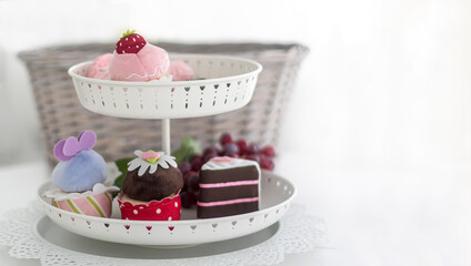 A vase with multi-colored pastries stands on a white background. There is a place to write