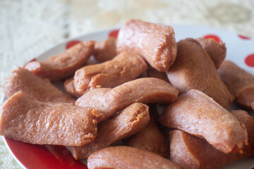 wooden Plate with hot sausages. Fried sausages on a plate.