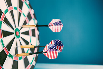 dart arrow hitting in the target center of dartboard.