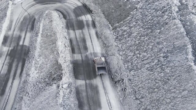 Aerial view shot, open pit mine, dumpers, quarrying extractive industry, stripping work. High quality 4k footage