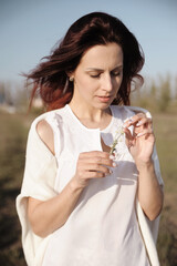 Woman sitting on the grass. Summer time relax for young woman.