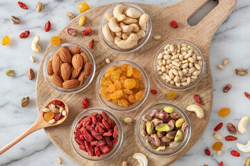 assorted dried seeds and fruit in glass saucers
