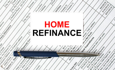 Text Home Refinance written on a business card lying on financial tables with a blue metal pen