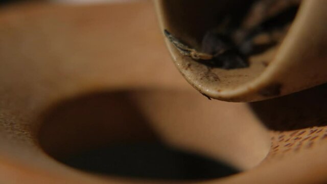 The tea master pours tea from the chahe into the teapot. Slow motion close-up, macro shot. Traditional Chinese tea drinking ceremony. Chinese Japanese tea, Puer Shu Gong Ting Xiao Tocha Oolong Zhang